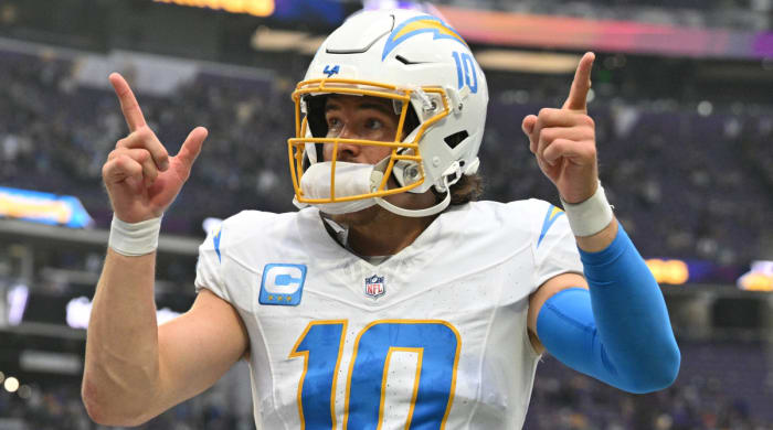 Chargers quarterback Justin Herberts points to the crowd after a win